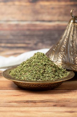 Dried mint spice. Dried mint leaves in bowl on rustic table. Dry spice concept