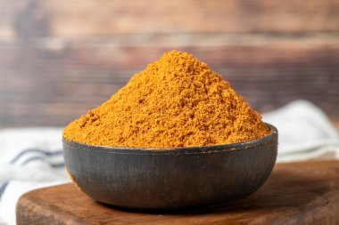 Meatball spice in bowl on rustic table. Meatball seasoning is a spice mix consisting of cumin, coriander, ground red pepper, thyme, black pepper, onion, garlic and dried parsley. Dry spice concept