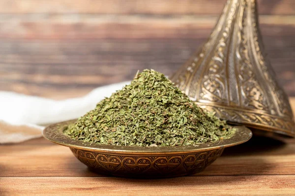 Dried mint spice. Dried mint leaves in bowl on rustic table. Dry spice concept