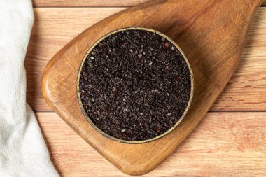 Black hot pepper spice in bowl. Chili pepper is a hot spice obtained by drying the pepper in the sun. Dry spice concept. local name isot. Top view