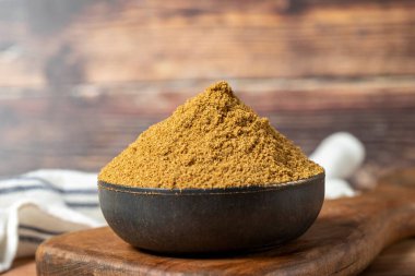 Powdered cumin spice. Cumin spice in bowl on wooden background. Dry spice concept. close up