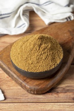 Powdered cumin spice. Cumin spice in bowl on wooden background. Dry spice concept. close up