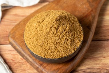 Powdered cumin spice. Cumin spice in bowl on wooden background. Dry spice concept. close up