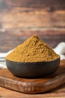 Powdered cumin spice. Cumin spice in bowl on wooden background. Dry spice concept. close up