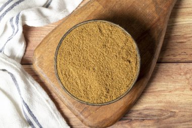 Powdered cumin spice. Cumin spice in bowl on wooden background. Dry spice concept. Top view