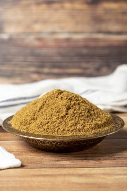 Powdered cumin spice. Cumin spice in bowl on wooden background. Dry spice concept. close up