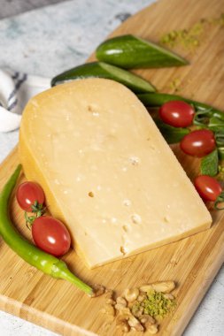 Gouda cheese. Piece of gouda cheese on wooden cutting board. Cheese collection. Ripe hard cheese made from cow's milk in the Netherlands