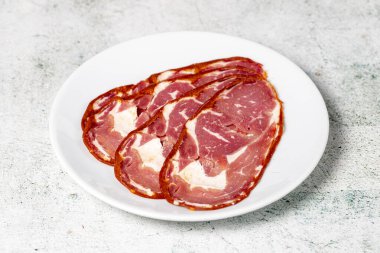 Beef ribeye bacon. Dried Turkish pastrami slices in plate. Traditional Turkish delicacies. Close up