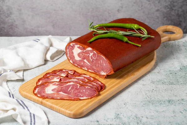 Beef ribeye pastrami. Dried turkish bacon slice on wooden Cutting Board. Traditional Turkish delicacies. Local name cemenli pastirma