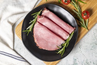 Beef salami slice in plate. Dried smoked ribeye salami. Top view