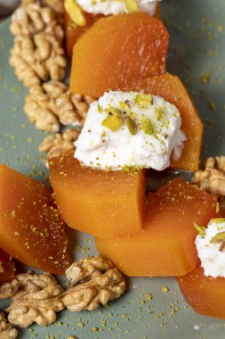 Creamy pumpkin dessert. Turkish Ramadan sweet delicacies. Pumpkin dessert with sorbet on gray background. Top view