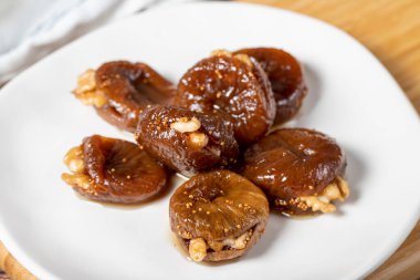 Walnut stuffed figs. Traditional Turkish sweets. Fig dessert with sherbet and walnuts. Close up