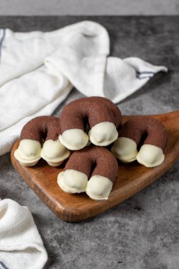 Cocoa and white chocolate cookies. Delicious cookies on dark background