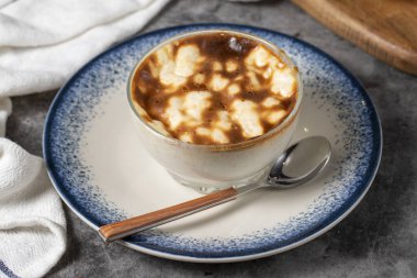 Rice pudding. Traditional Turkish cuisine desserts. Rice pudding dessert made with milk, sugar and rice on a dark background. Local name sutlac. Close up