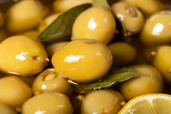 Cheese stuffed olives. Close-up pile of green olives with olive oil and spices