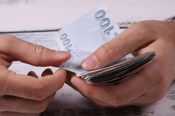 stock image Young man counting Turkish banknotes in his hand. Turkish Lira TRY or TL