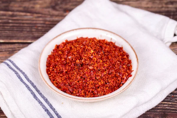 Chilli pepper seedless flakes. Dried red pepper flakes in bowl. Spices and herbs.