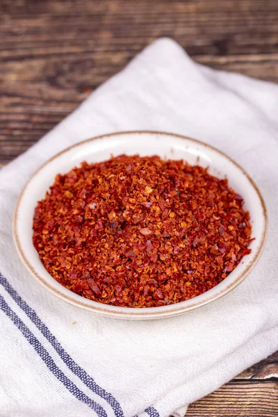 Chilli pepper seedless flakes. Dried red pepper flakes in bowl. Spices and herbs.