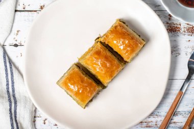 Türk baklavası. Ahşap arka planda fıstıklı baklava. Geleneksel Akdeniz mutfağı lezzetleri. Üst görünüm
