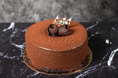 Çikolatalı pasta. Doğum günü ya da kutlama pastası. Kakaolu kek ve koyu arkaplanda çikolata kreması..