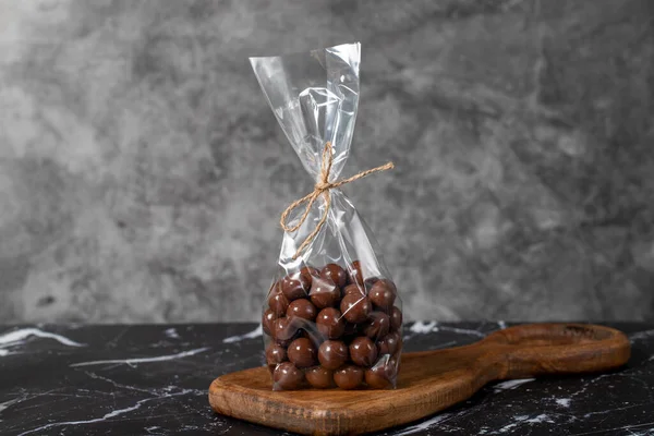 Packed chocolate. Chocolate with hazelnut snack on dark background