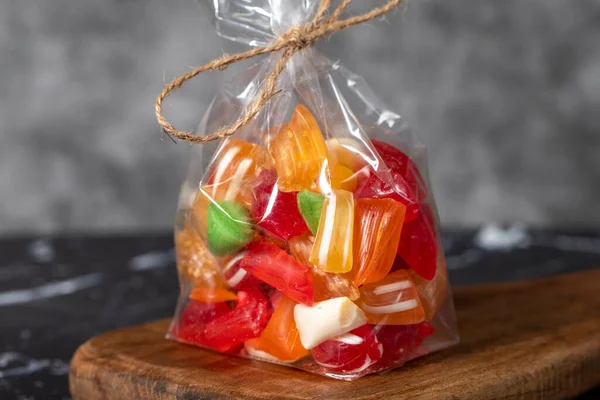 Fruit drops. Packed fruit flavored candy on a dark background. Close up