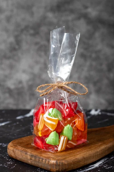 Fruit drops. Packed fruit flavored candy on a dark background