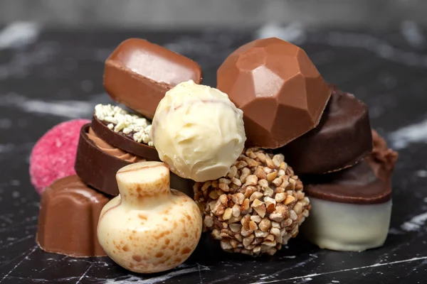 stock image Praline Chocolate. Assorted truffles or praline chocolate on dark background. Close up