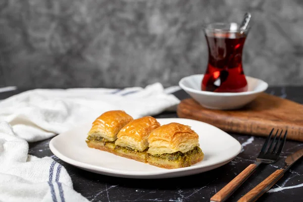 stock image Pistachio baklava. Pistachio baklava with syrup on a dark background. Turkish cuisine delicacies