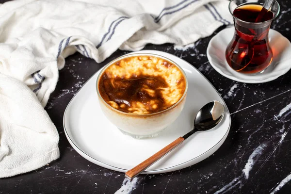 Rice pudding on a dark background. Rice pudding dessert made with milk. Turkish cuisine delicacies