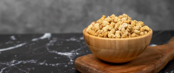 stock image Dried mulberry Sun-dried organic white dried mulberry in wooden bowl. Superfood, Vegetarian food concept. healthy snacks. Copy space. Empty space for text