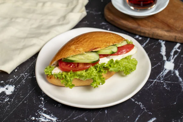 stock image Sandwich with cheese, tomato, cucumber and lettuce. Delicious sandwich on dark background