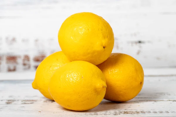 Lemon on a white wood background. Fresh raw lemon harvest season concept. Vegetables for a healthy diet