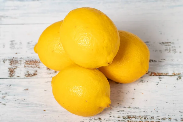 Lemon on a white wood background. Fresh raw lemon harvest season concept. Vegetables for a healthy diet