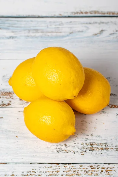 Lemon on a white wood background. Fresh raw lemon harvest season concept. Vegetables for a healthy diet. Close up