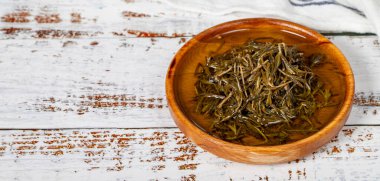 Tahta kasede zeytinyağlı siyah kekik. Beyaz ahşap arka planda Zahter. Akdeniz yemekleri. Vejetaryen yemeği. Uzayı kopyala Metin için boş boşluk