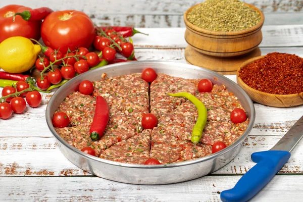 Minced meat tray kebab on wooden background. Tray kebab, famous in Hatay city of Turkey. Flavors of Turkey. Close up