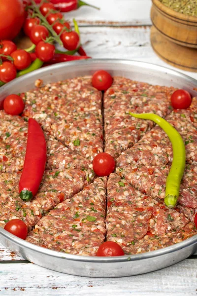 Minced meat tray kebab on wooden background. Tray kebab, famous in Hatay city of Turkey. Flavors of Turkey. Close up