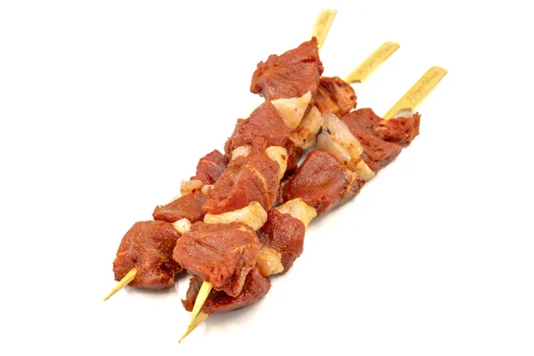 Beef tenderloin skewer isolated on white background. Beef tenderloin skewer with raw sauce with herbs and spices