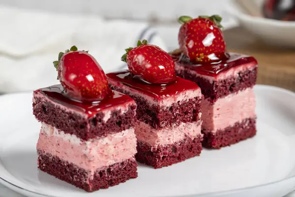 Small slices of cake. Strawberry and cream cake slices on a plate. snack sweet food. Close up