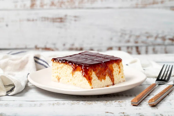 Tres leches cake. Slices of trilece cake with milk and caramel on a wooden background. patisserie products