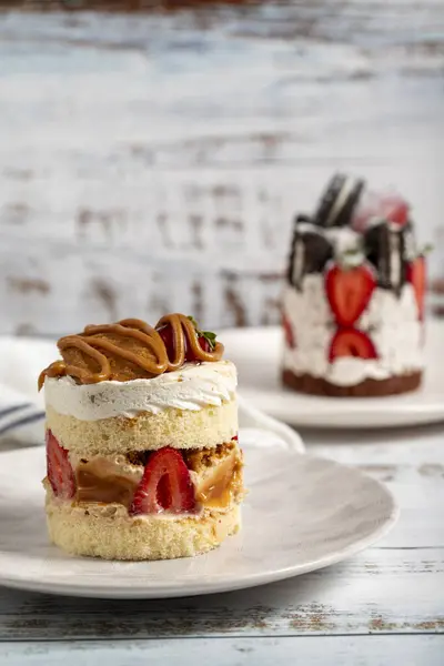 Types of cakes. Fresh cakes with strawberries on a plate
