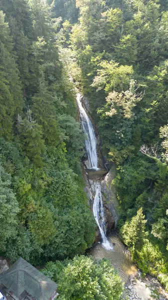 Waterfall flowing in the green forest. Local name manle waterfall. Aerial view