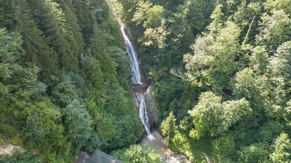Waterfall flowing in the green forest. Local name manle waterfall. Aerial view