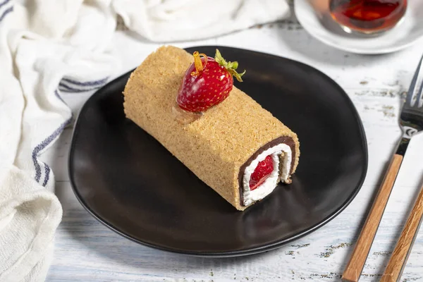 Roll cake. Strawberry roll cake with delicious cream on a white background