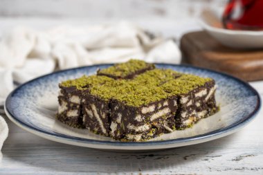 Beyaz arka planda fıstıklı ve bisküvili kurabiye. Nefis kakaolu kurabiyeler. Kapat.