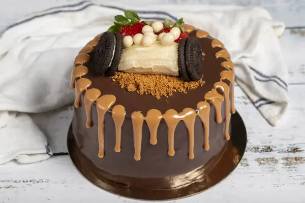 Birthday cake. Chocolate and caramel cake on a white background