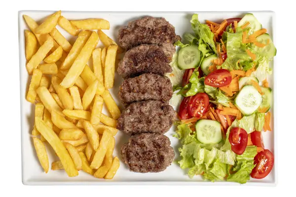 Grilled meat balls. Grilled meatballs with salad and fries isolated on white background.