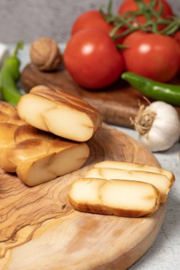 Tütsülenmiş Çerkez peyniri. Kesme tahtasında tütsülenmiş Çerkez peyniri. Yerel adı isli cerkez peyniri. Kapat.