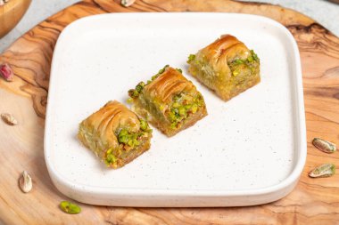 Cimcik baklava. Akdeniz mutfağı aromalı. Kırsal masada Türk kahvesi, ramazan ya da bayram tatlıları konsepti olan şam fıstıklı baklava. Kapat.